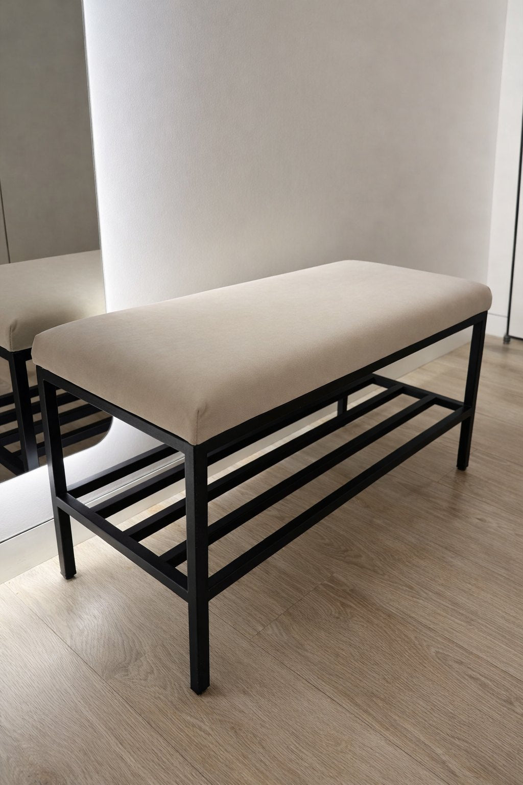Metal entryway bench with cushioned seat and shoe rack storage
